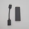 A black HDMI streaming stick and its connected cable are placed on a white background. Náhled obrázku produktu