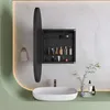 A modern bathroom vanity with a sink, faucet, and a medicine cabinet with its door open, displaying toiletries. Podgląd zdjęcia produktu