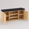 A shoe cabinet with a black upholstered seat on top, shown against a plain light gray background. One of the cabinet doors is open, revealing shelves inside. Náhľad obrázku produktu