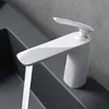 A white faucet with water running into a dark gray sink. Anteprima dell’immagine prodotto