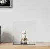 A rocket-shaped object displayed inside a clear acrylic cube on a wooden surface. Voir les images du produit