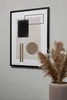 A framed abstract art print with geometric shapes in neutral tones, displayed on a light gray wall next to a vase of dried pampas grass. Podgląd zdjęcia produktu