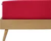 A close-up view of a red fitted sheet on a wooden bed frame. Produktbild-Vorschau