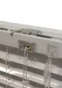 A close-up view of the top mechanism of a set of white Venetian blinds, showing the cord and tilt control. Produktbild-Vorschau
