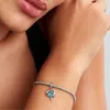 A close-up shot of a woman's arm wearing a Pandora charm bracelet with a blue heart-shaped charm. Anteprima dell’immagine prodotto