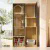 A cat condo with multiple levels, scratching posts, a glass-enclosed section with a cat, and storage compartments for pet food and a litter box. Podgląd zdjęcia produktu