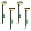 Four black solar garden lights with yellow light and blue solar panels, each with a green tag attached. Náhľad obrázku produktu