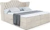 A studio shot of a bed with a tufted headboard, two pillows, and a blanket. Produktbild-Vorschau