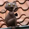 A metal cat figurine sits on a tiled roof. Produktbild-Vorschau