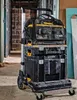 A DeWalt tool cart with multiple storage containers and a bag is shown in a construction or renovation environment. Anteprima dell’immagine prodotto