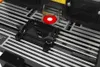 A close-up view of a router table with a router bit and a fence attachment. Anteprima dell’immagine prodotto