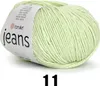 A ball of light green yarn with a label. Podgląd zdjęcia produktu