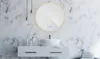 A modern bathroom vanity with a round LED mirror above a sink. Voir les images du produit