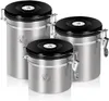 Three stainless steel canisters with black lids are arranged in a group. Anteprima dell’immagine prodotto