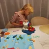 A young girl is playing with a toy. Anteprima dell’immagine prodotto