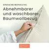A hand is shown unzipping a beige pillow cover. Produktbild-Vorschau