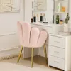 A pink velvet chair with gold legs is placed in front of a white vanity table with various cosmetic products. Náhľad obrázku produktu
