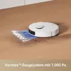 A robot vacuum cleaner is shown on a wooden floor, demonstrating its suction power with a projected graphic. Produktbild-Vorschau