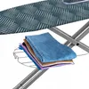 A close-up shot of a folded ironing board with clothes on a rack below it. Produktbild-Vorschau