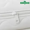 A close-up view of a white mattress topper with a zipper. Produktbild-Vorschau