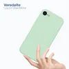 A hand holding a light green phone case against a white background. Produktbild-Vorschau