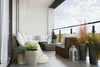 A balcony furnished with outdoor seating and planters. Anteprima dell’immagine prodotto