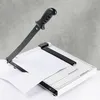 A paper cutter is shown on a white surface against a gray concrete wall. Produktbild-Vorschau