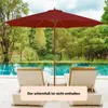A red patio umbrella is set up next to a swimming pool with lounge chairs. Anteprima dell’immagine prodotto