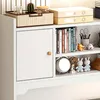 A close-up view of a white shelving unit with various items on display. Náhled obrázku produktu