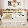 A bedroom scene featuring a beige upholstered daybed with a built-in bookshelf headboard, decorated with various items and artwork on the wall. Anteprima dell’immagine prodotto