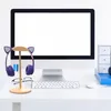 A pair of purple headphones with cat ears sits on a wooden stand in front of a computer monitor. Náhľad obrázku produktu
