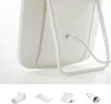 The back of a white LED makeup mirror with a charging cable plugged in. Below are images of various charging accessories. Produktbild-Vorschau