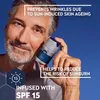 A man holding a Nivea Men product against a blue sky background. Produktbild-Vorschau