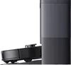 A side view of a robot vacuum cleaner docked in its charging station. Voir les images du produit