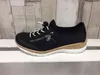A single navy Rieker slipper is displayed on a white shelf against a light wood-paneled background. Produktbild-Vorschau