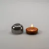 A glass cover and a lit candle are placed side-by-side on a gray background. Produktbild-Vorschau