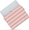 A pink laptop sleeve with a quilted design is shown with a gray laptop partially inserted. Náhľad obrázku produktu