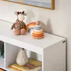 A close-up view of a white shelf with children's toys and decorative items. Anteprima dell’immagine prodotto