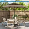 A patio set with a large umbrella, table, and chairs on a wooden deck, surrounded by a wooden fence and greenery. Náhled obrázku produktu