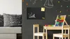 A child's play area with a chalkboard wall, a small table and chairs, and educational toys. Podgląd zdjęcia produktu