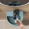 A hand is cleaning a small, light blue wall-mounted sink with a black faucet. The sink has some yellow residue inside. The background consists of tiled walls. Anteprima dell’immagine prodotto