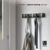 A wall-mounted coat rack with two items hanging on it. Anteprima dell’immagine prodotto