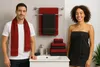 A man and a woman are standing in a bathroom next to a sink and towels. Produktbild-Vorschau