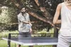 A man and a woman playing table tennis outdoors. Produktbild-Vorschau