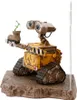 A Wall-E figurine holding a plant in a boot, standing on a textured base. Anteprima dell’immagine prodotto