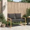 A garden bench with cushions on a patio, next to plants and a fence. Anteprima dell’immagine prodotto