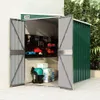An open garden shed with tools and storage boxes inside, set against a wall and foliage. Náhľad obrázku produktu