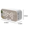 A white digital alarm clock with a mirrored display showing the time and other indicators. Produktbild-Vorschau