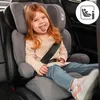 A young girl with red hair sits in a car seat, sticking her tongue out. Produktbild-Vorschau