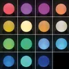 A grid of 15 images, each showing a different colored illuminated sphere against a black background. The spheres vary in color from red, purple, orange, yellow, cream, green, light blue, and blue. Produktbild-Vorschau